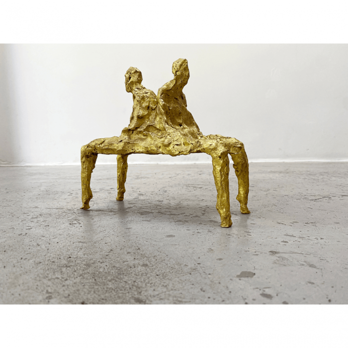 Zwei Figuren Rücken an Rücken die eine Sitzbank bilden, vergoldet Gold